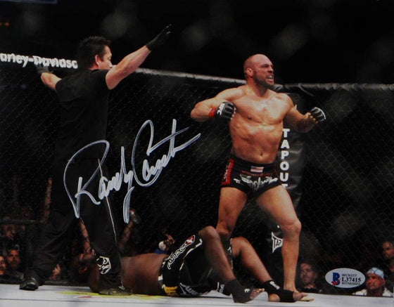 Randy Couture Autographed UFC 8x10 Photo Knock Out- Beckett Auth White Ref Facing Couture - 757 Sports Collectibles