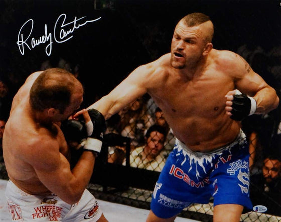 Randy Couture Autographed UFC 16x20 Hit By Liddell Photo- Beckett Auth White - 757 Sports Collectibles